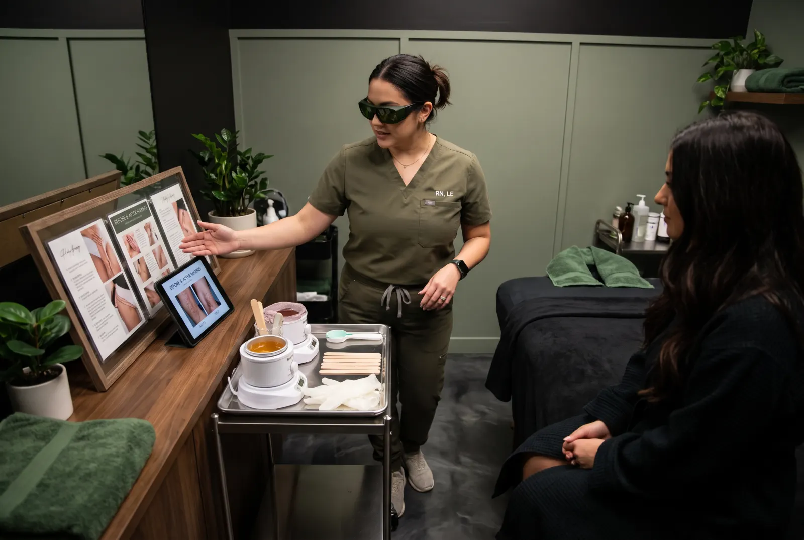 Licensed esthetician discussing waxing Cedar Rapids services consultation